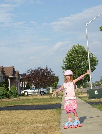 Trying out her new in-line skates.  Ta-Da!