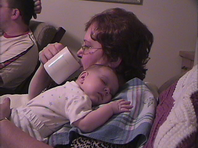 Grandma Karen taking a sip while Ashlynn catches some zzz's