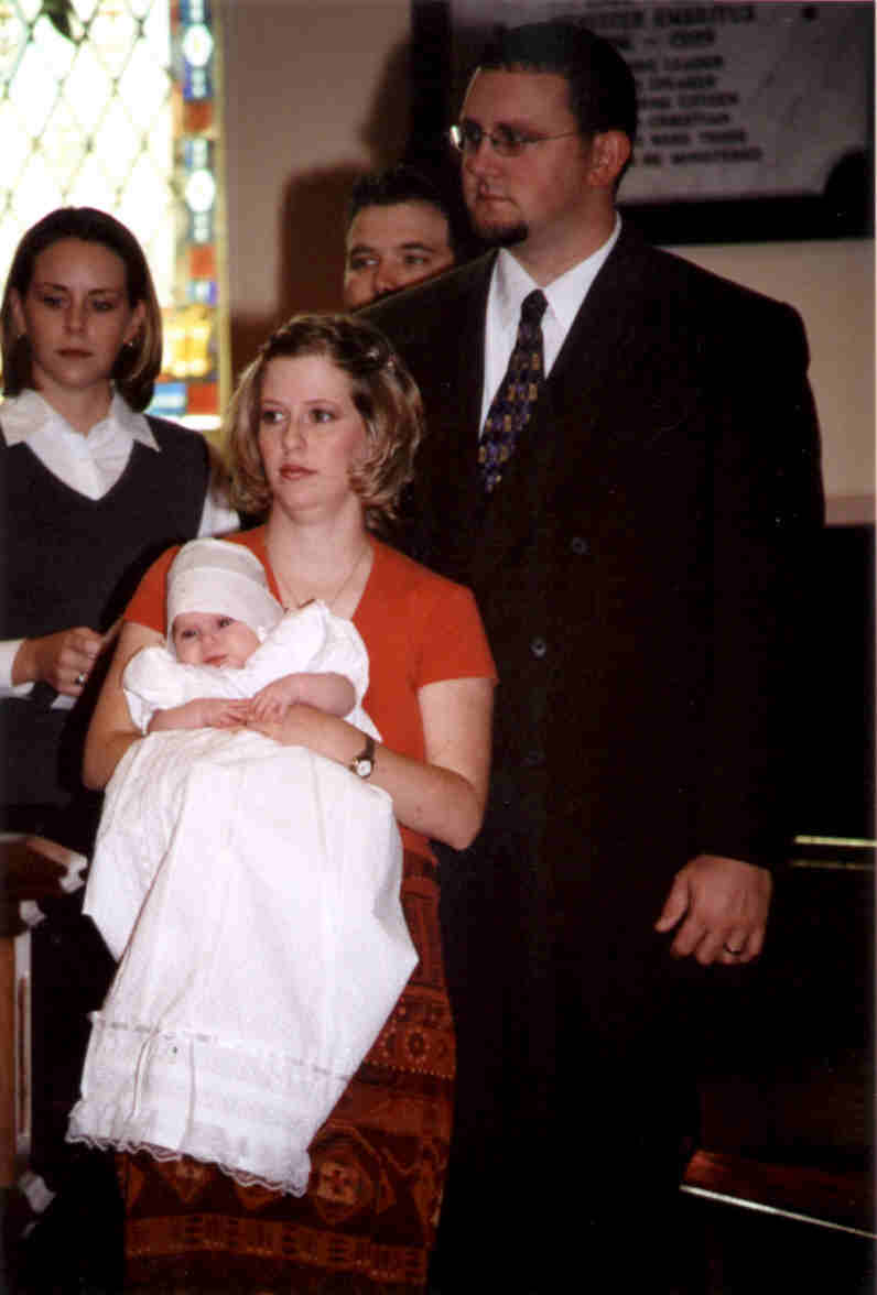 Mom & Dad waiting, with Godmother Raemie and Godfather Scott