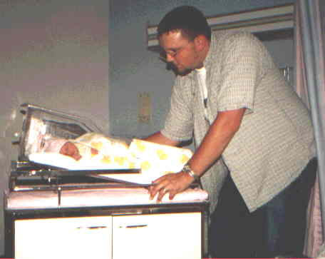 Dad looking at his new bundle of joy